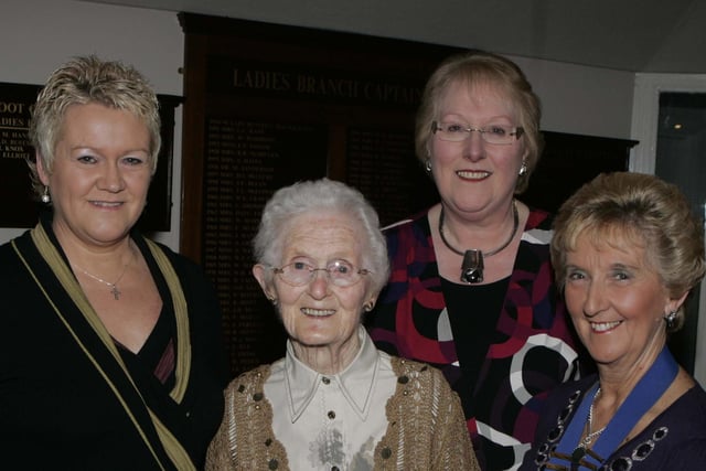 Mary McCurdy receives Honorary Membership for 45 years service from President Joan Campbell as Roberta McKeeman and Janice Gault look on at the 58th annual dinner of Bushmills WI held at Bushfoot golf club in 2010