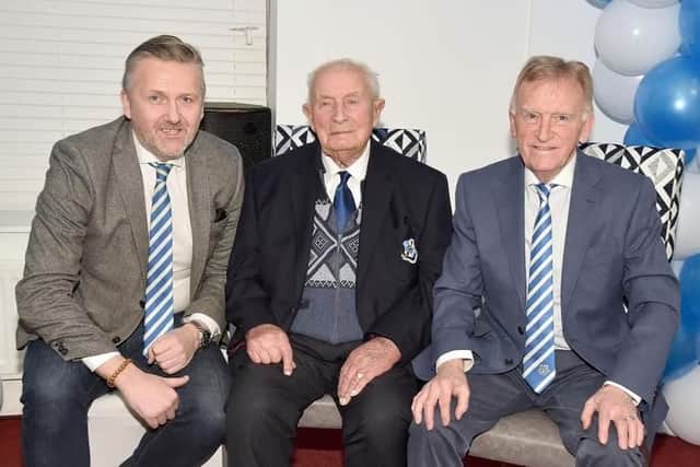 Hilbert Willis pictured at his 100th birthday party in February 2024 with Loughgall FC chairman, Councillor Sam Nicholson, left, and club president, Noel Willis. Picture: Tony Hendron