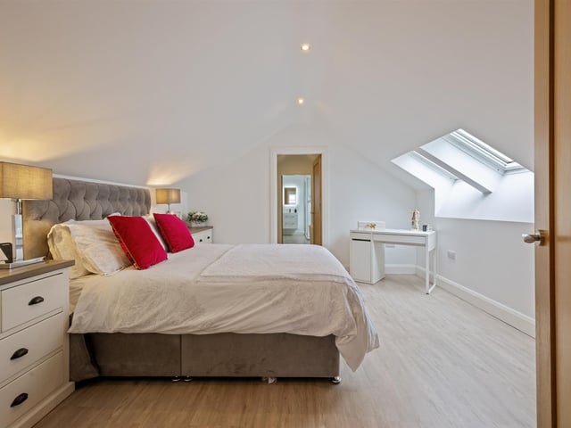 Principal bedroom with access to walk-in wardrobe and en-suite.