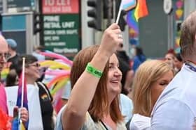Head of the NI Civil Service Jayne Brady waving a 'progress' flag - a contested symbol of the LGBTQ+ movement - at Belfast Pride.
