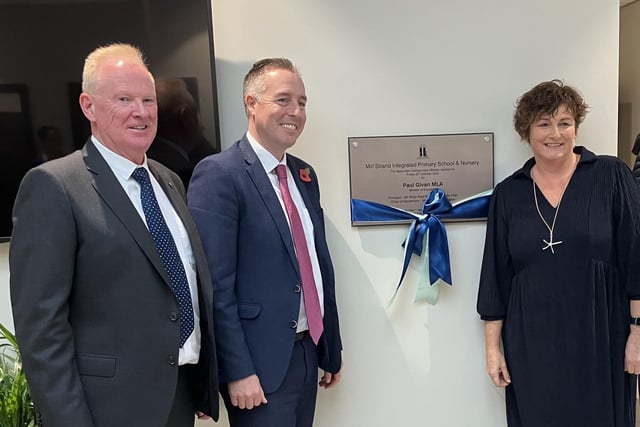 Education Minister Paul Givan unveils a plaque at Mill Strand Integrated Primary Schoool in Portrush with principal Philip Reid and chair of governors Louise Rossington.