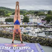 Eleanor Smart of the USA prepares to launch an armstand dive from the 21 metre platform during the final competition day of the fourth stop of the 2024 Red Bull Cliff Diving World Series at Ballycastle Harbour, Causeway Coast, Northern Ireland on July 20, 2024.