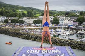 Eleanor Smart of the USA prepares to launch an armstand dive from the 21 metre platform during the final competition day of the fourth stop of the 2024 Red Bull Cliff Diving World Series at Ballycastle Harbour, Causeway Coast, Northern Ireland on July 20, 2024.