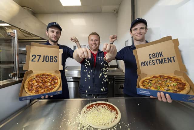 Store owner, Darren Colgan (centre) is joined by two team members, Bart Zielinski (left) and Anthony Collins to celebrate the opening of Four Star Pizza, Ireland’s biggest indigenous pizza company, in Craigavon.