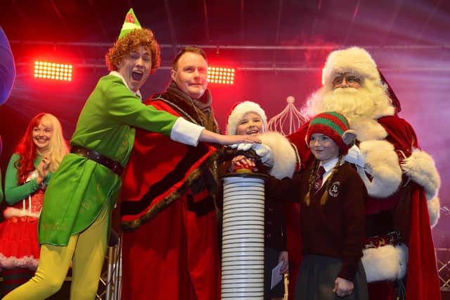 Anna and Nancy Nicolls from Loanends Primary School helping the Mayor of Antrim and Newtownabbey, Councillor Mark Cooper, switch on the Crumlin lights with Santa and Buddy the Elf/