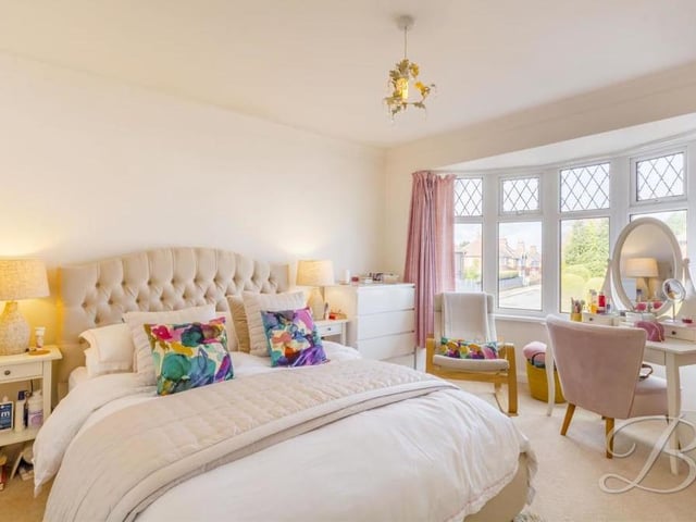 A second view of one of the main bedrooms, which shows how bright and spacious it is. There is even room for a dressing table and chairs.