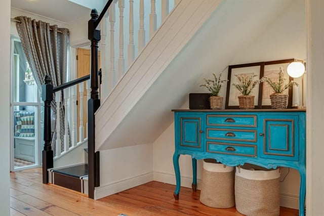 Hallway with tongue and groove flooring.