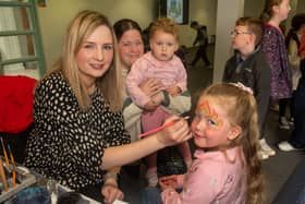 Laura Noble of Funky Face Painting completes another masterpiece on Myla Stewart (5) as mum, Nicola and little sister, Emily look on. LM17-206.