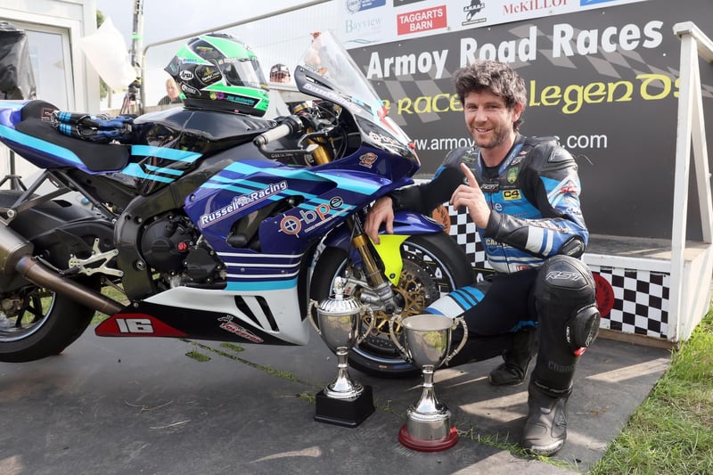 Mike Browne (BPE/Russell Racing Honda) celebrates winning the Race of Legends at Armoy road races with his team.