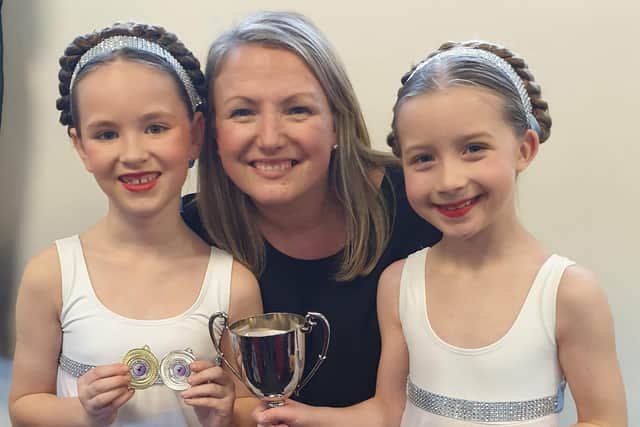 Sonia Stewart with Brooke McConkey and Lucia Greene plus some silverware at a past Ballymena Festival.