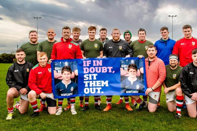 Larne team members with the concussion awareness banner.
