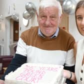 Tenant Jeff Shaw and Jessica McBride, Choice scheme co-ordinator at Pound Green Court, with a cake to mark the milestone. Photo submitted by Choice