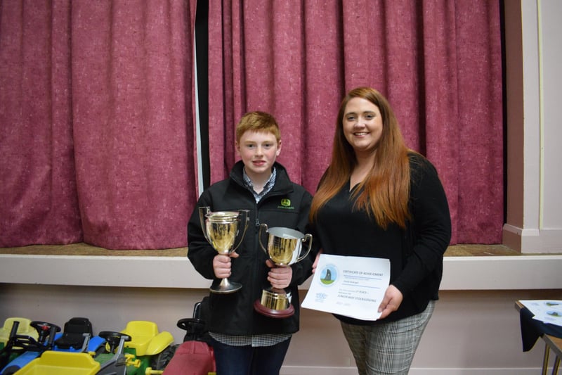 Charlie McKnight receiving his awards for Ulster Young Farmer and Beef Stockjudging from Shannen Vance.