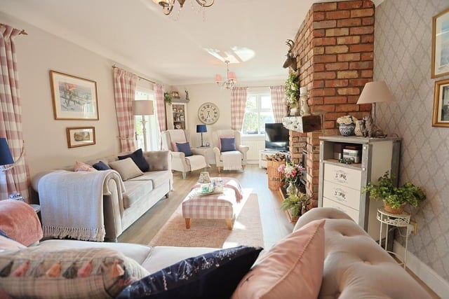 The spacious lounge has a cottage style red brick fireplace with mantle sleeper and stove, cove cornice ceiling, a laminate floor and French doors leading to the conservatory.