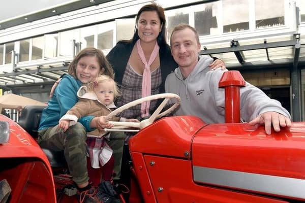 Posing on at tractor during the 2022 Country Comes To Town event are from left: Aaron Adams, Tara-Rose Samolia McLarnon, Anca Samolia McLarnon and Neil McLarnon. Picture: Tony Hendron