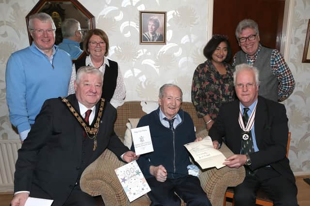 Mayor Councillor Steven Callaghan and Deputy Lieutenant for Co Antrim, Peter Mackie, join Alex McElreavey and his family as they celebrated his 100th birthday. Credit Causeway Coast and Glens Council