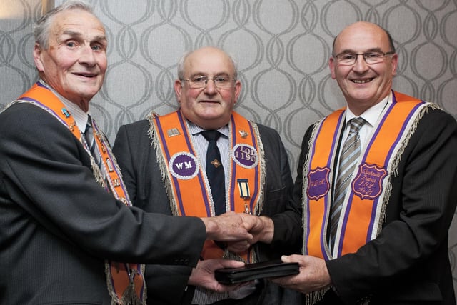 Tommy McAlister presents John Taggart a gift to mark his long service as Treasurer of Ballyoglagh LOL 1190 at a special dinner held at the Causeway Hotel in 2010. Included is W.M. James McConaghie