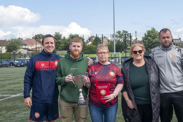 Celebrating the inaugural Terence Pentland Memorial Cup are family members Bryan (second left), Kim and Trudie, plus Chris Wright (Portadown, left) and Gary Magee (Rectory Rangers). (Photo by Portadown FC)