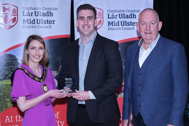 Chair of the Council, Councillor Córa Corry presents Fergal Rainey with his award, after he won Young Architect of the Year, pictured alongside nominating councillor Sean McPeake.
