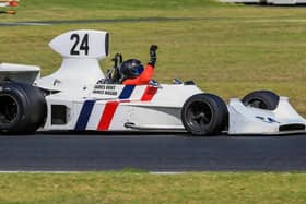 James Hagan waving to the crowd after winning the 2023 Phillip Island Historic Grand Prix in Australia. James is driving the original 1974 Hesketh 308.