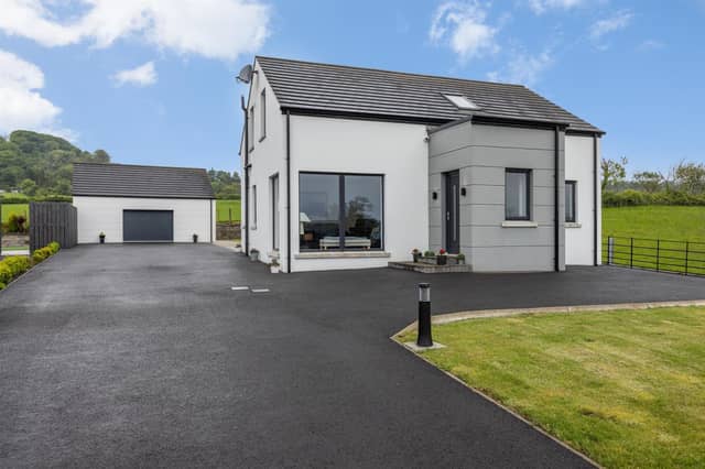 Exterior of the family home with matching detached double garage.