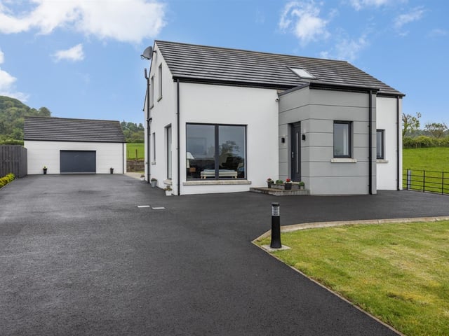 Exterior of the family home with matching detached double garage.