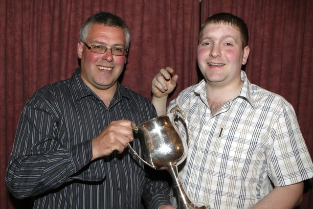 Ballymoney Darts League held their annual presentation night in 2008 at Ballymoney Utd Social Club. And pictured receiving the Joey Dunlop Memorial Cup from Ricky Dunlop, (beaten finalist)  is winner, Alwyn McCosh