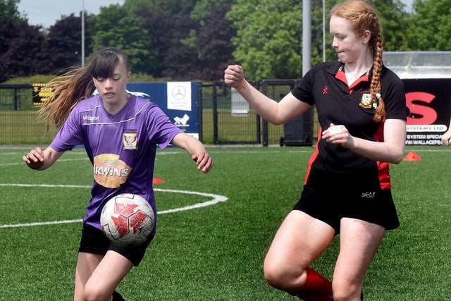 Brownlow Integrated College (purple) players in action against Lagan Integrated College at the Electric Ireland schoolgirls soccer tournament at Lurgan Town FC on Friday. PT21-234.