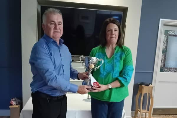 Overall winner Dianne Gallagher receives the cup from Hugo Downey