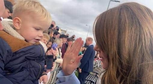 The Princess of Wales and Mason prepare to high five.
