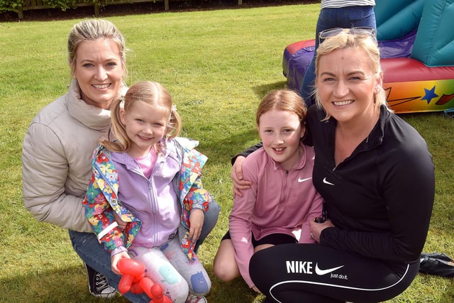 Enjoying the good weather at the Loughgall coronation fun day at the parish rectory are, from left, Judith Boyce and daughter Averie (4) and Elsie Moore (9) and mum Christine.PT18-278.