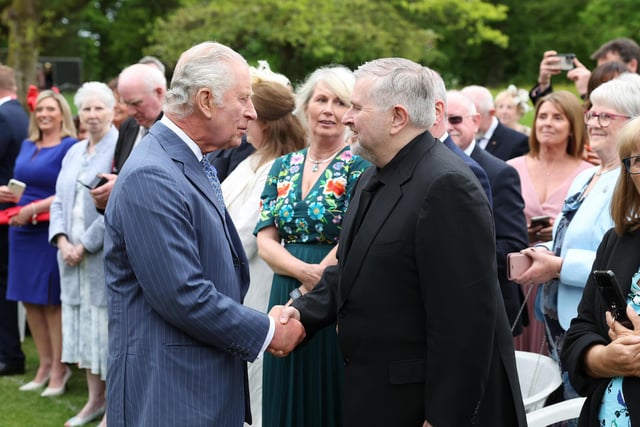 King Charles meets Fr Gary Donegan during the Hillsborough Castle garden party.
