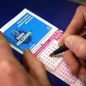 Filling out a lottery ticket.