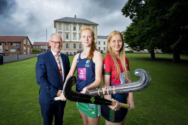 Dr David Carruthers pictured with Coleraine Grammar School hockey first XI co-captains Kia McCartney and Hope Ross. Credit Morrow Communications