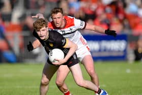 Down's Patrick McCarthy escapes a tackle from Louth's Ryan Burns during their recent meeting at Pairc Esler. Pic: Brendan Monaghan
