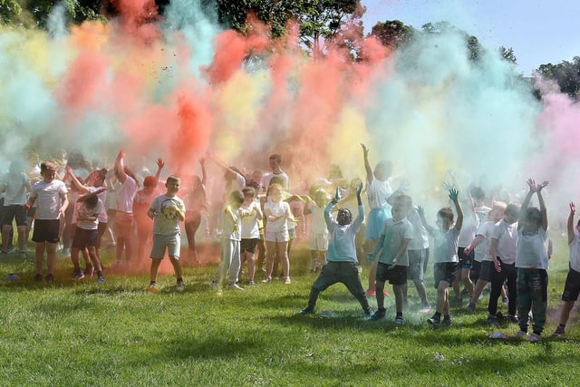 Children from Ballyoran Primary School launch their coloured powders into the air on Thursday morning at the start of their charity colour run. PT21-200.
