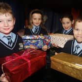 St. Joseph's Primary School Lisburn celebrated Christmas in 2007 by showing their generosity to children from Romania. The children and parents in the school collected toys and gifts in a shoe box. The shoe boxes were taken to Romania in time for Christmas. Included are Cenka Drayne, Lucy Woods, Jeremy Mc Elwee and Conor Dixon.