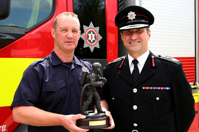 Stephen Mullan, from Limavady, who was awarded the On-Call to Wholetime Award for the trainee who has been deemed top among the trainees who joined on the accelerated training programme, with interim Chief Fire & Rescue Officer Andy Hearn.