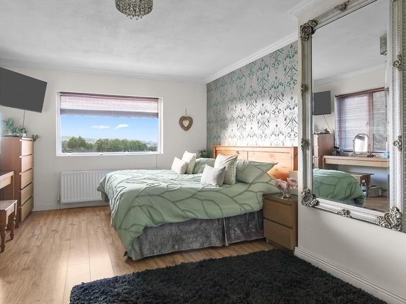 Bedroom with wood flooring.