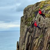 Members of the PSNI, staff, family and friends took part in a fundraising abseil down Fairhead to raise funds for Air Ambulance NI.