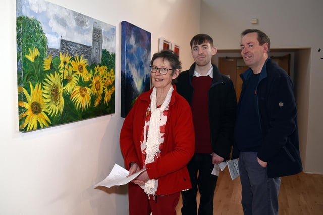 The Gallagher family - Marie, Mark and Peadar admiring some of the paintings on display at the Armagh Art Club exhibition. PT09-239.