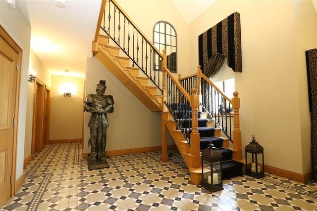 A beautiful church-style wooden front door leads into the spacious hallway with a feature decoration-only fireplace, eye catching oak staircase with wrought iron railings and carpet with brass rods, tiled floor with boarder, chandelier with five matching walls lights, brushed chrome double power points, under floor heating and a cloakroom.