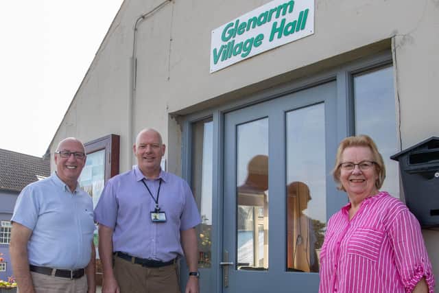 Pictured outside the new door at Glenarm Village Hall, which was funded by the Housing Executive are John Read, Housing Executive Good Relations Officer; Leslie Morrow, Glenarm Village Committee secretary and Francis Wilson, Glenarm Village Committee assistant chairperson.