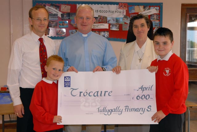 Tullygally Primary School pupils Che McCaughley and Boyd Jackson present £600 in 2007 for Trocaire to Father Martin McAllinden and Sister Rosemary. Included is Mr William Hanna, principal.