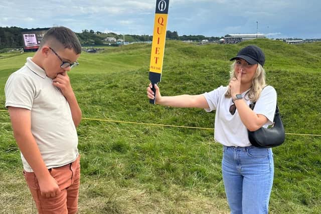 Big sister Erin pretending to call for quiet during The Open with brother Zain. CREDIT LINDA ATTIA