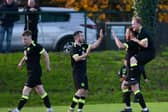 Cleary Celtic players Mark Hughes and Cathal O'Reilly congratulate first half goal scorer Brendan Coulter on Saturday.