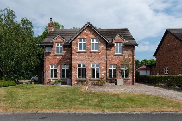 The property has a detached garage and garden space to the front and rear.