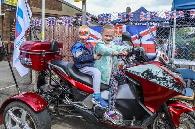The Royal British Legion's celebrations provided these young members of the community with an opportunity to try out a trike. Pics by Norman Briggs RnBphotographyni
