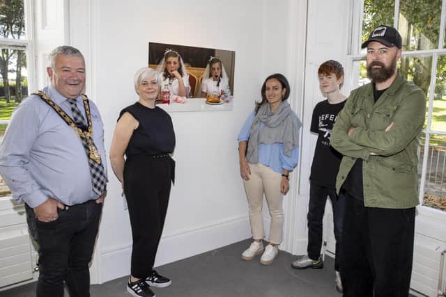 The Mayor of Causeway Coast and Glens Borough Council, Councillor Ivor Wallace, Shauna McNeilly Arts & Cultural Facilities Officer, Bronagh Rooney, Cathal’s son Dara and photojournalist Cathal McNaughton pictured at the opening of his new exhibition, Reflection, at Flowerfield Arts Centre