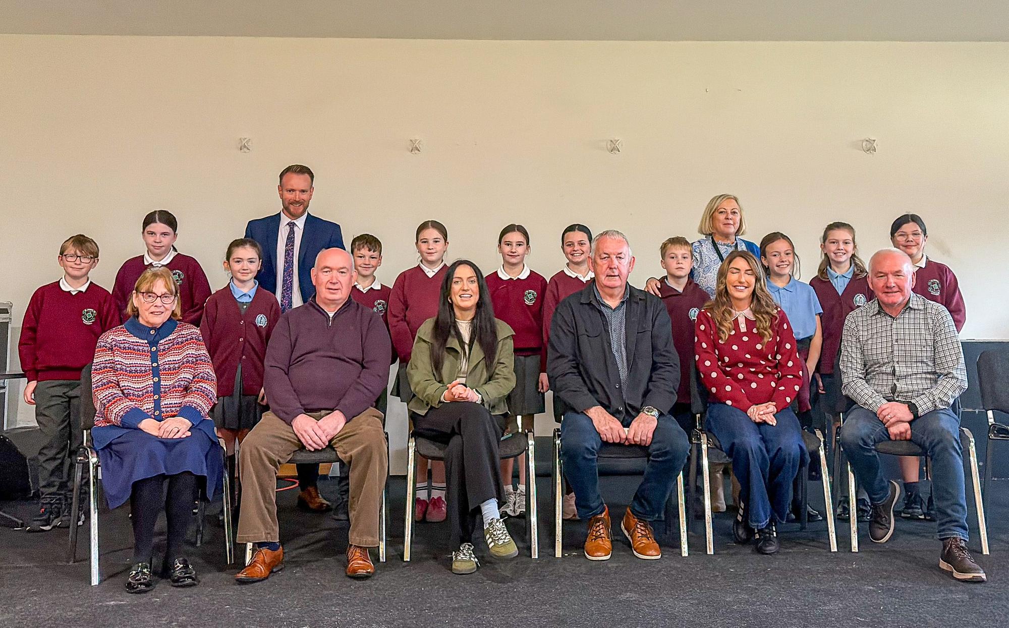 Political representatives pictures with teachers and pupils of St Brigid's and Knockloughrim Primary Schools.